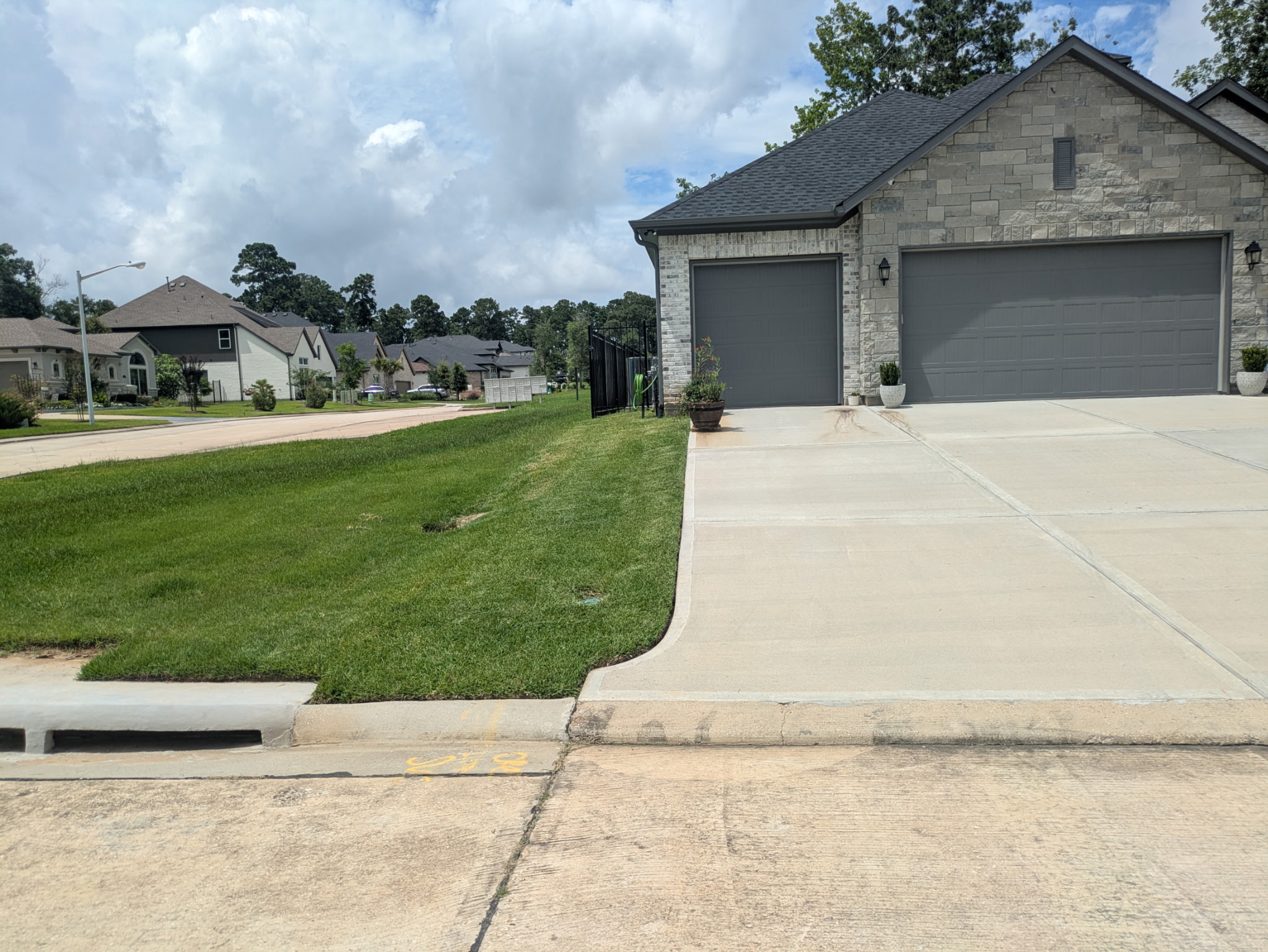 Manicured stone home front yard maintained by Nixon's Lawn Care